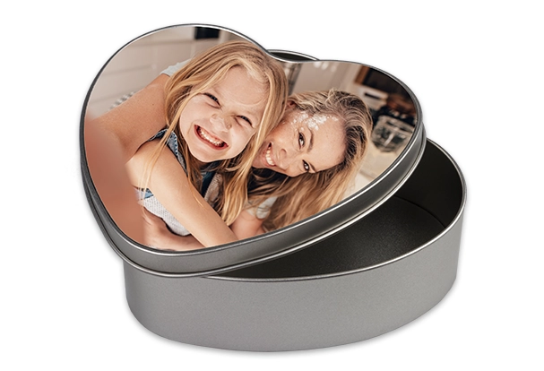Die herzförmige ROSSMANN Fotodose aus Metall eignet sich perfekt für persönliche Erinnerungen mit eurem Lieblingsmotiv.