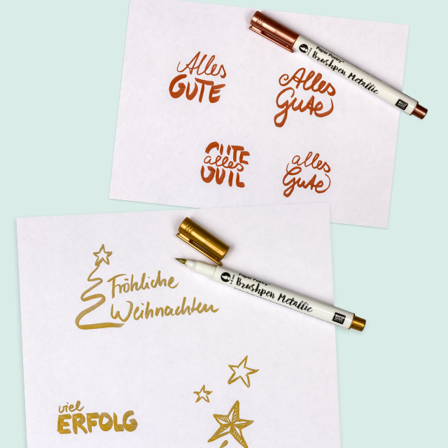 Brushpens in Metallicfarben und kreative Wünsche mit Illustrationen und Text auf Papier.
